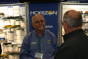 Craig Walker of Athearn Trains visits with a consumer at Saturday's Trainfest in Milwaukee. Athearn was among more than five dozen manufacturers who unveiled new products, made announcements and displayed the latest in model railroading. - Tim Blackwell/Cowcatcher Magazine